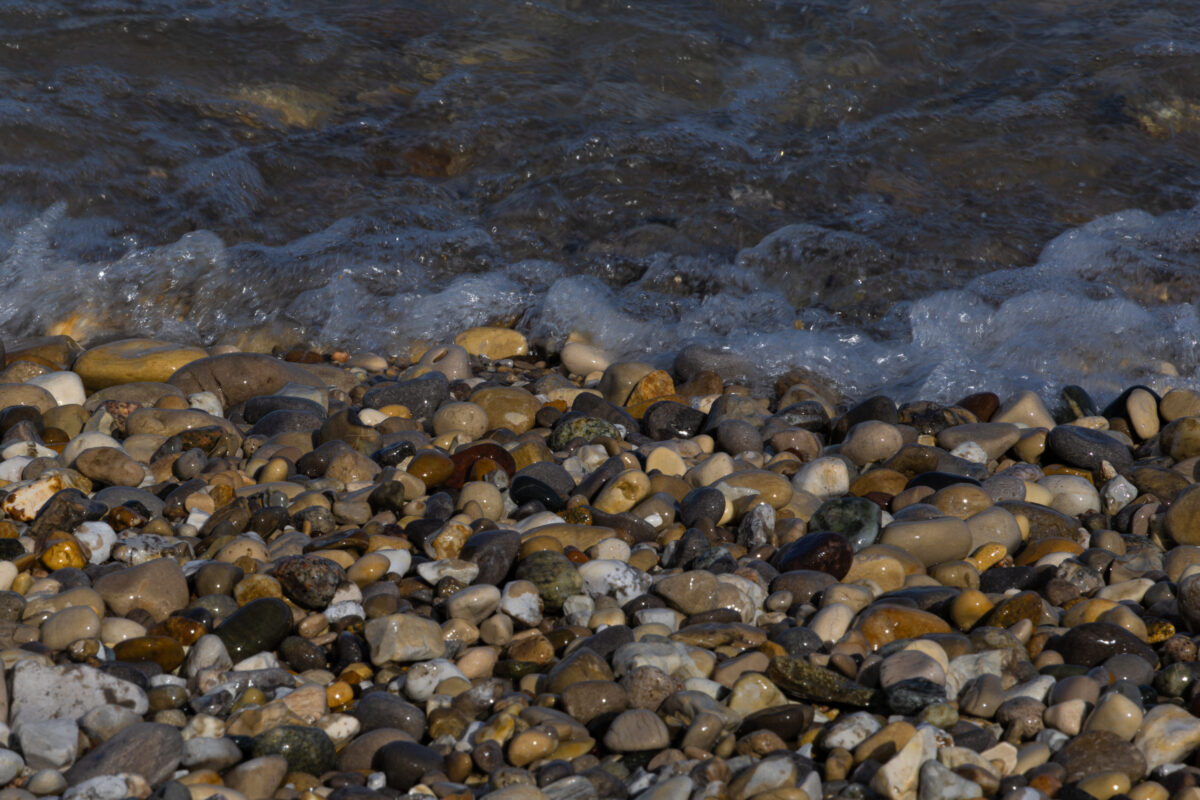 Lake Michigan shoreline with glistening wet rocks and reflected light