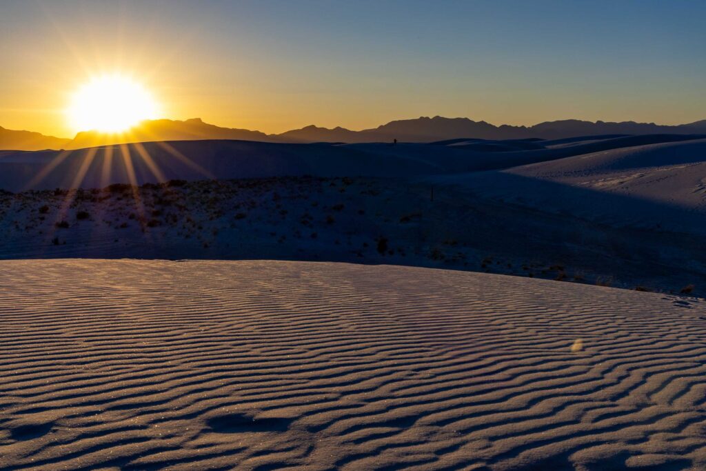 Sunset shadows on white gypsum dunes at White Sands National Park
