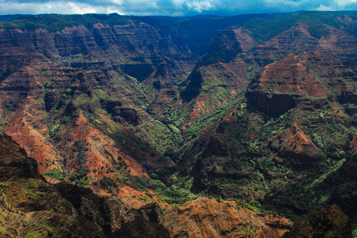 Waimea Canyon Kauai with red volcanic cliffs and lush green valleys