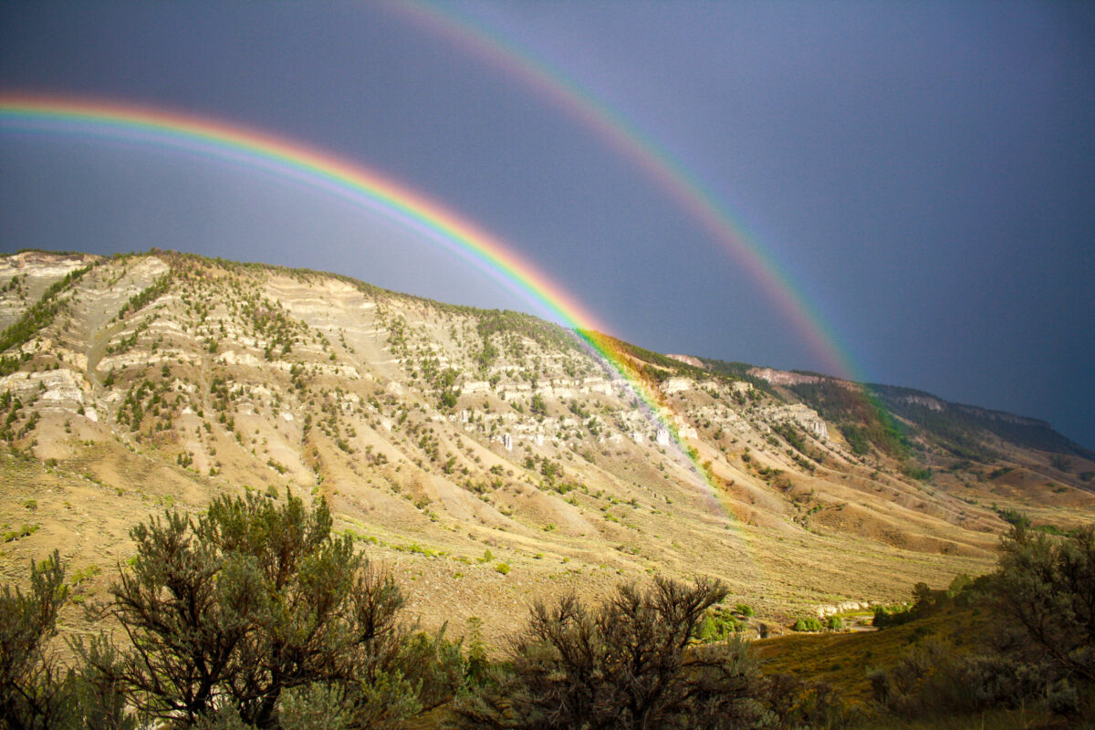 Yellowstone landscape with a bright double rainbow after a storm