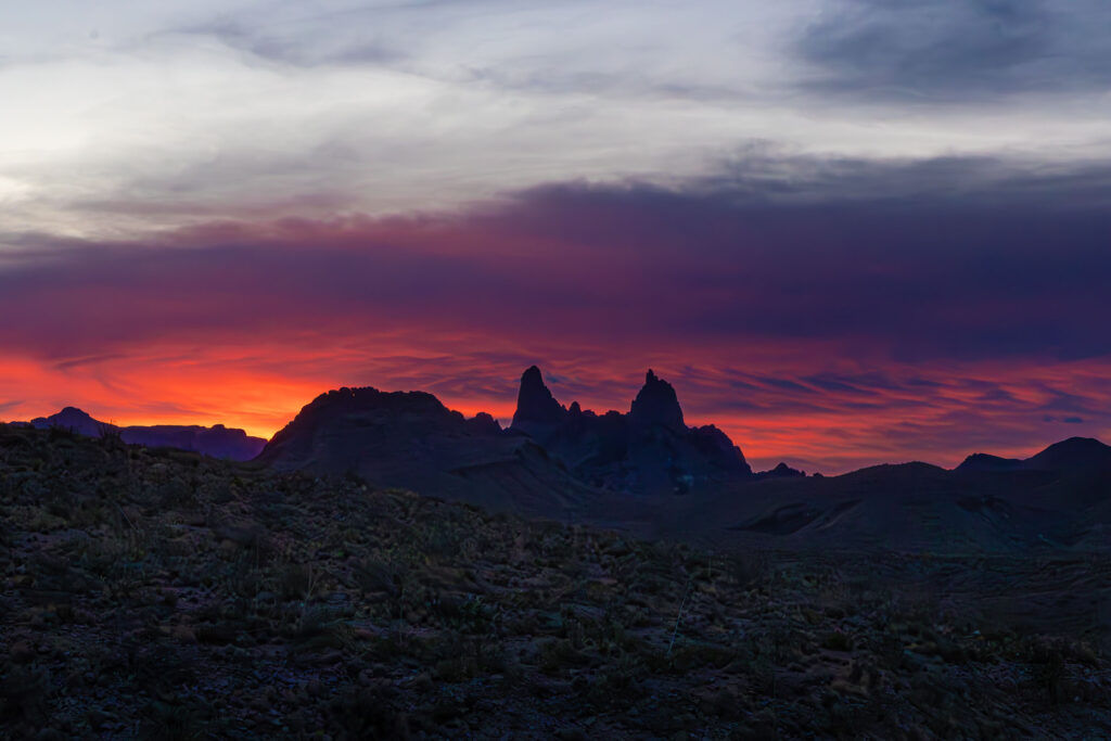 Mule Ears peaks at sunrise in Big Bend with warm sky