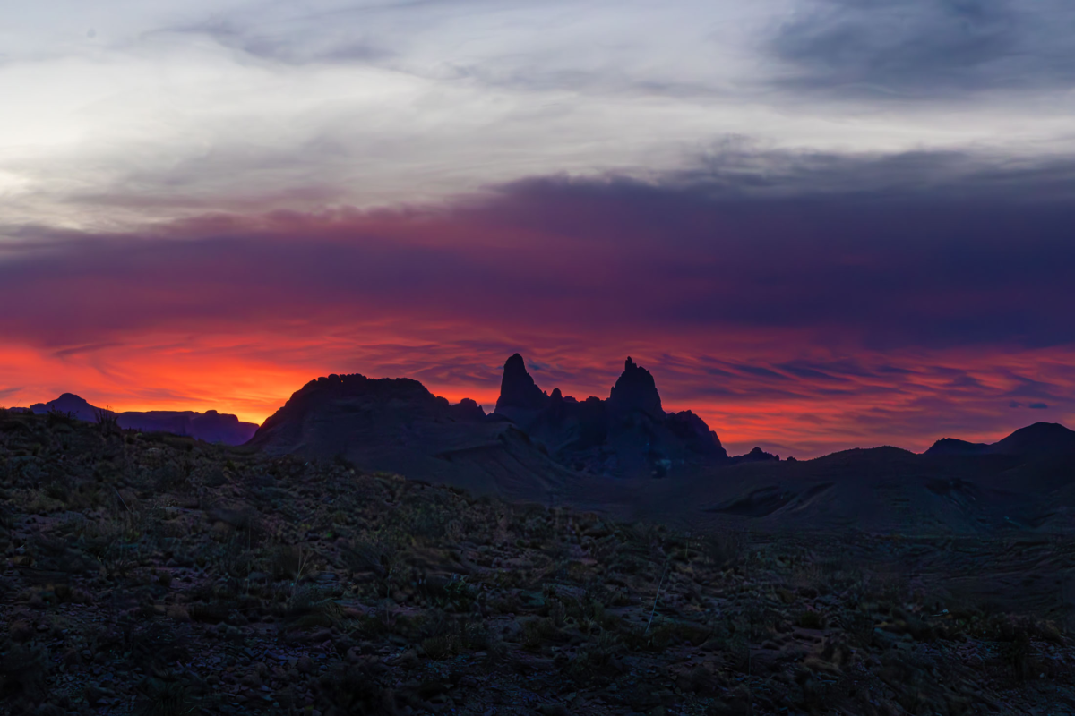 Mule Ears peaks at sunrise in Big Bend with warm sky