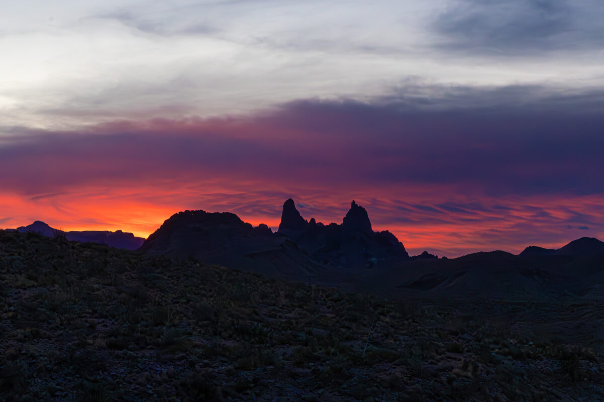 Mule Ears peaks at sunrise in Big Bend with warm sky