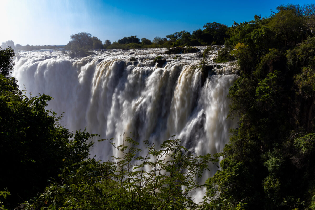 Powerful Victoria Falls flows rapidly across it's broad expanse