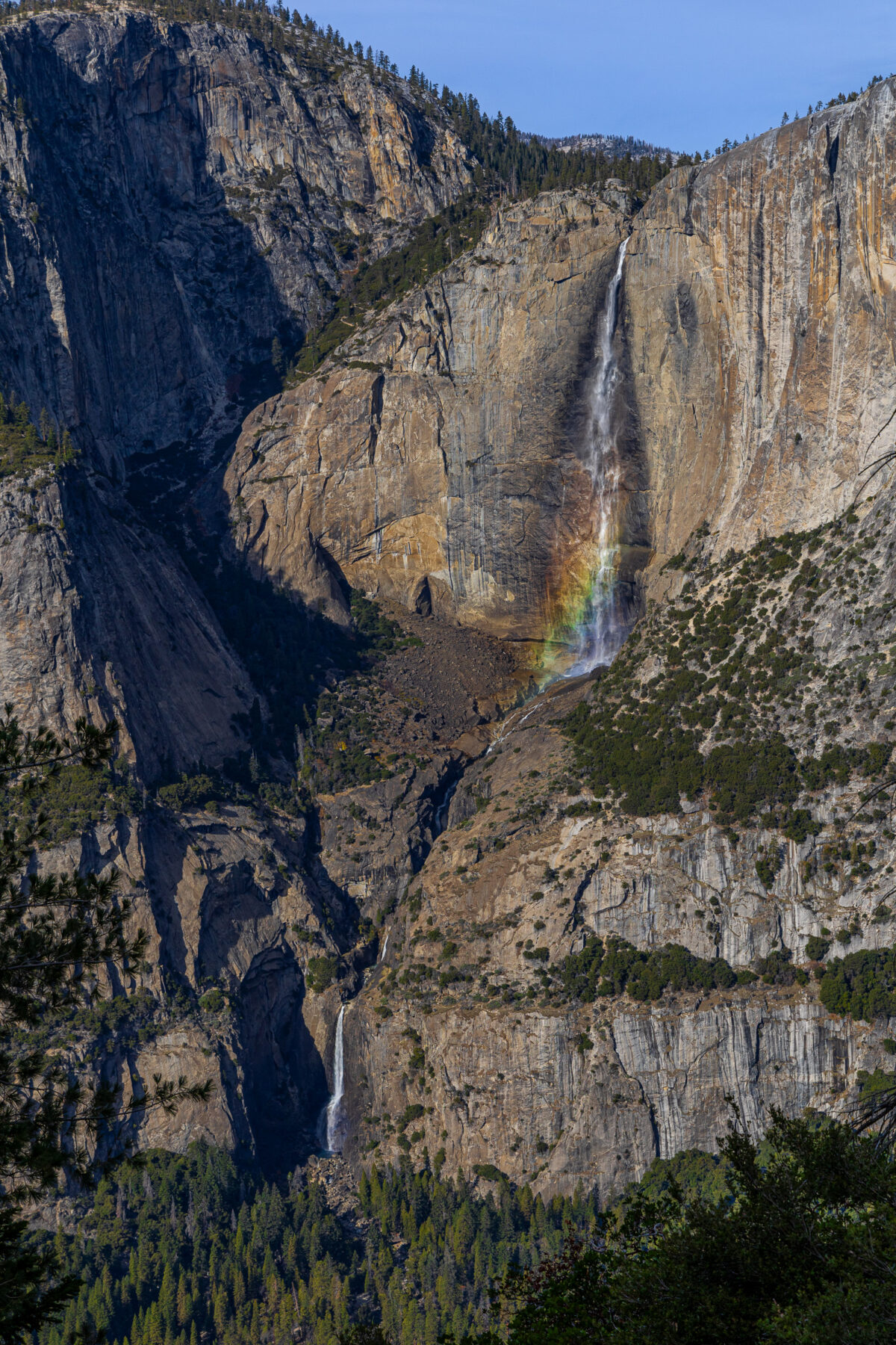 Yosemite Falls rainbow in mist with granite cliffs, Yosemite National Park