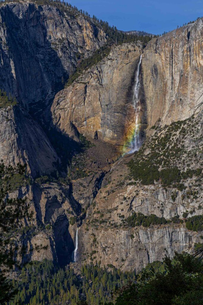 Yosemite Falls rainbow in mist with granite cliffs, Yosemite National Park