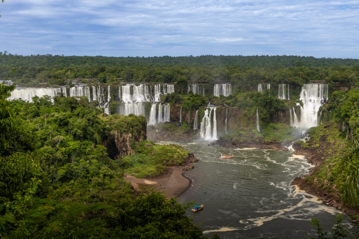 Multiple Iguazú Falls cascades flowing through rainforest cliffs on the Argentina–Brazil border