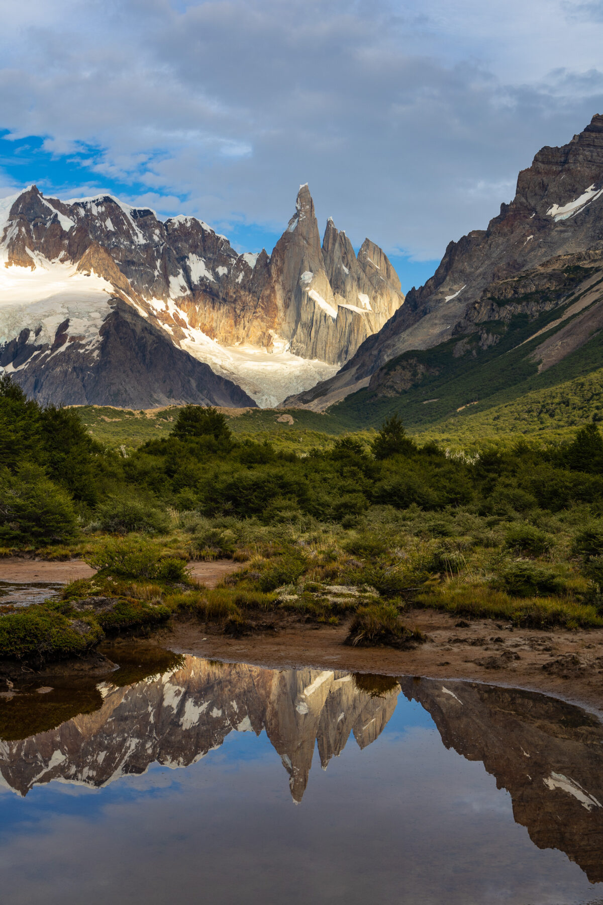 Vertical reflection of Cerro Torre mirrored in calm water in Patagonia, Argentina