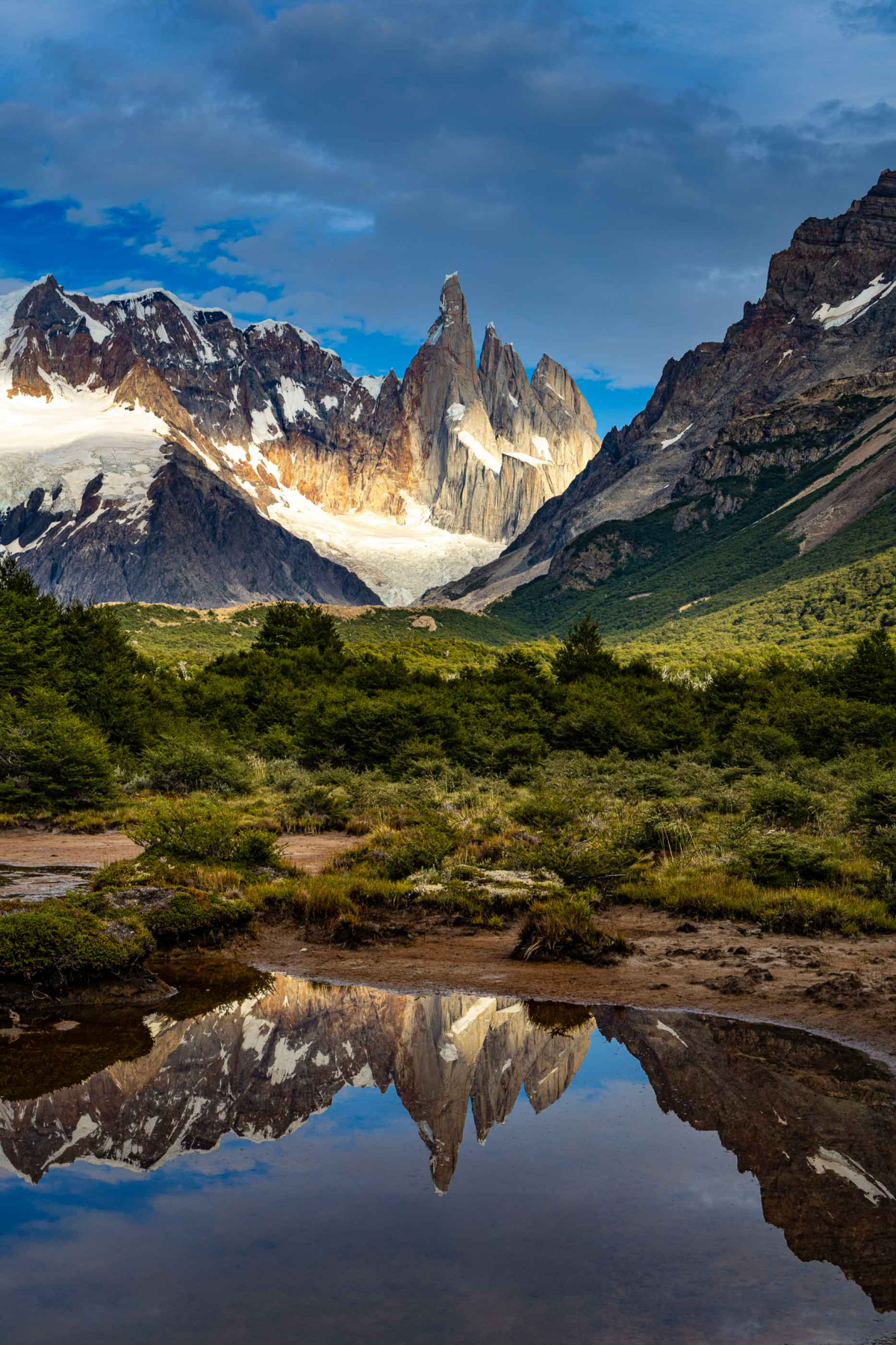 Vertical reflection of Cerro Torre mirrored in calm water in Patagonia, Argentina