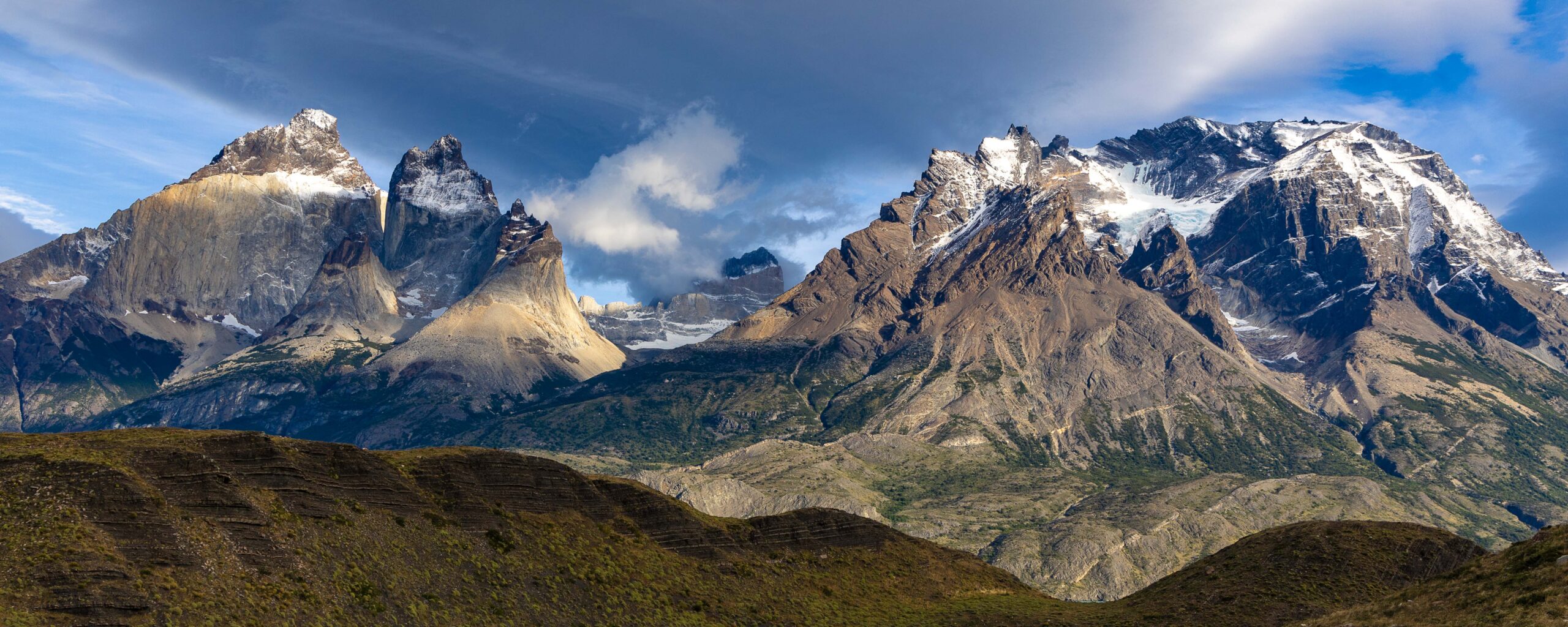 Panoramic view of Torres del Paine mountains under dramatic clouds in Chilean Patagonia