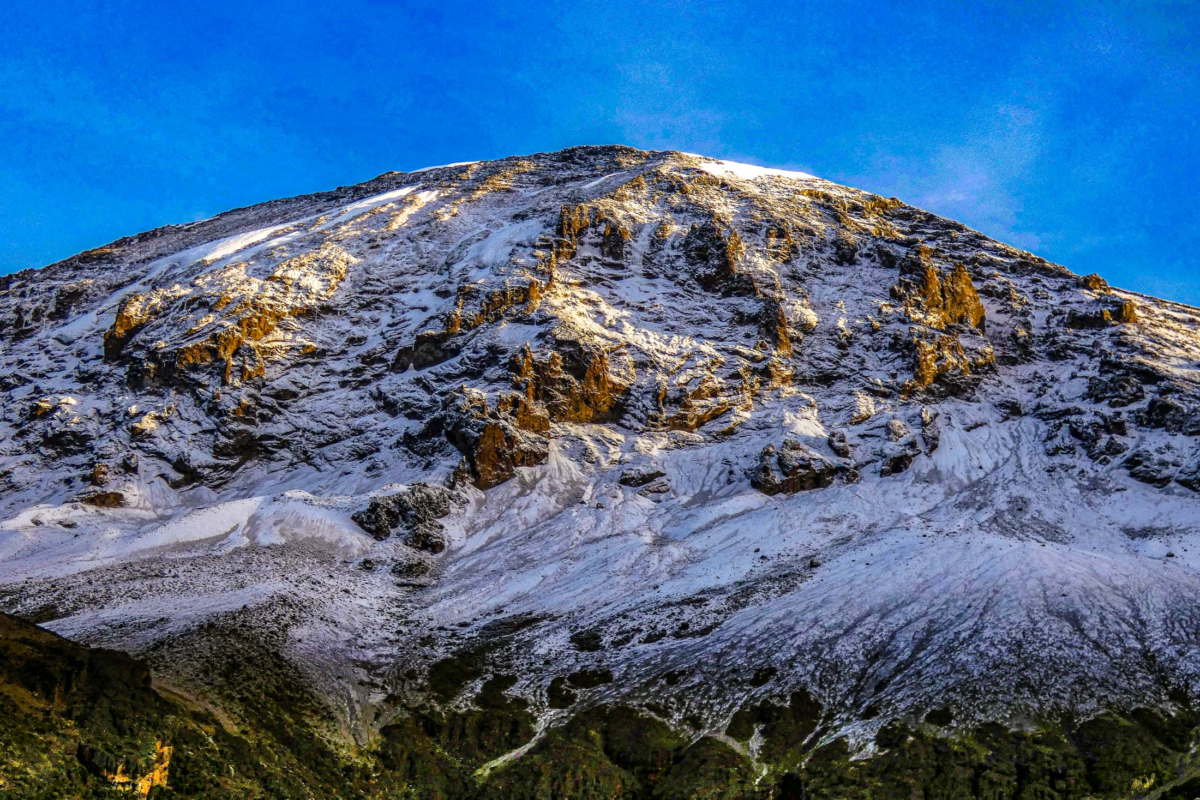 Fresh snow on Mount Kilimanjaro viewed from Karanga Camp on the Lemosho route in early morning light