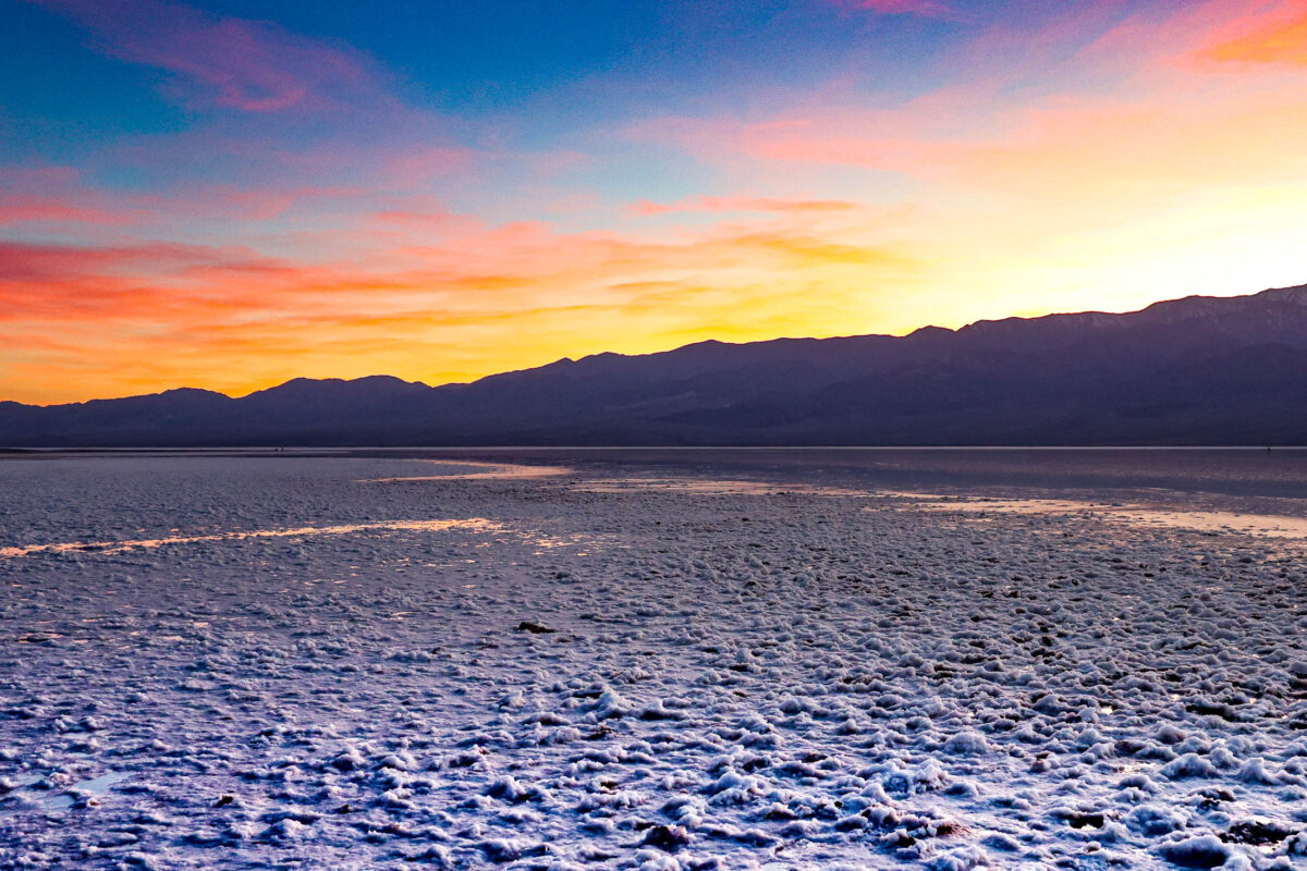 Panoramic sunset over salt flats at Badwater Basin in Death Valley