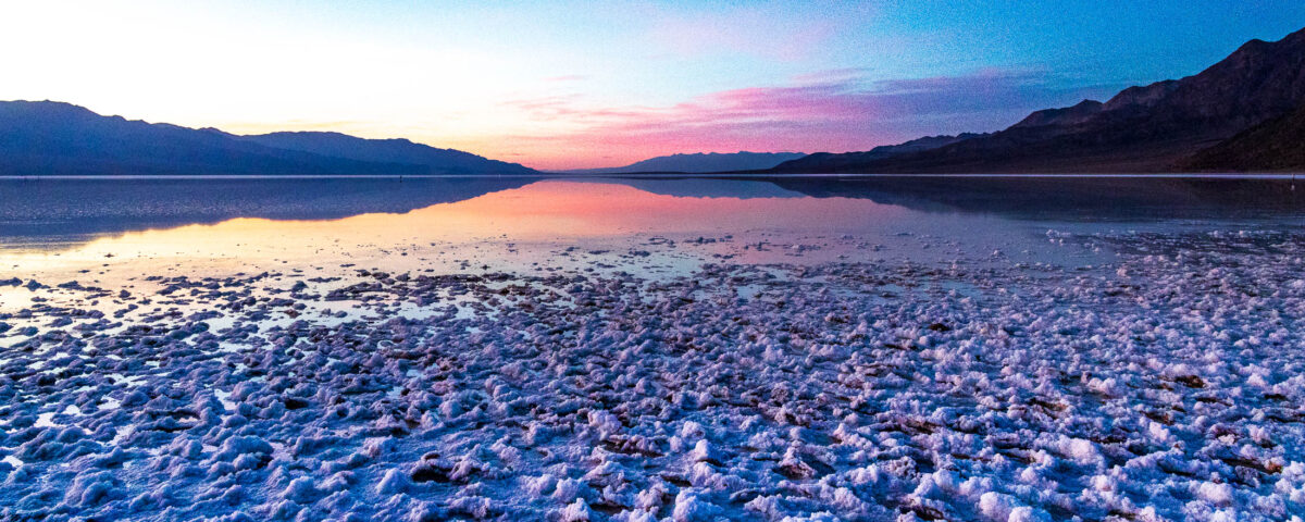 Panoramic sunset over salt flats at Badwater Basin in Death Valley