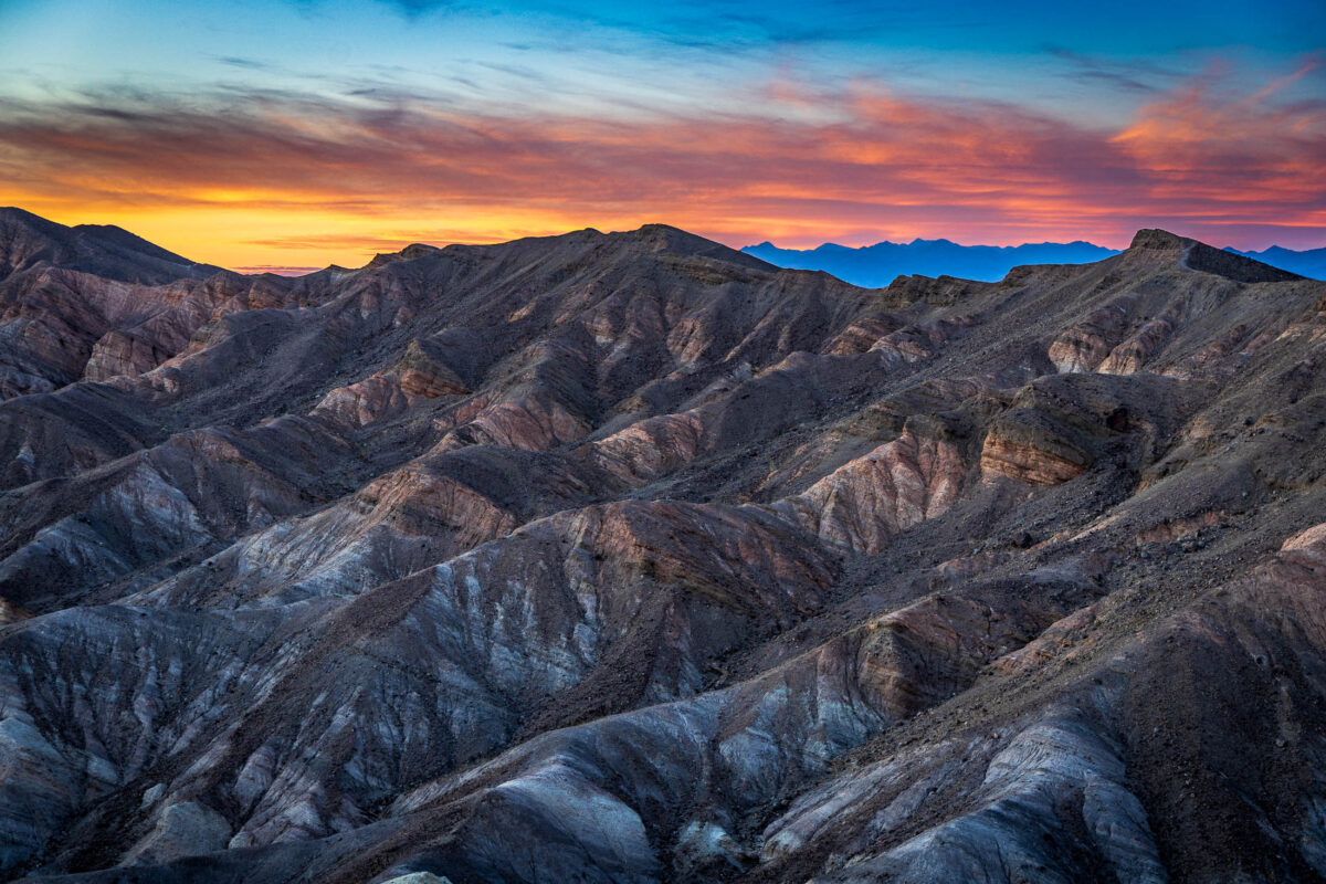 Sunset over layered desert ridges at Zabriskie Point in Death Valley