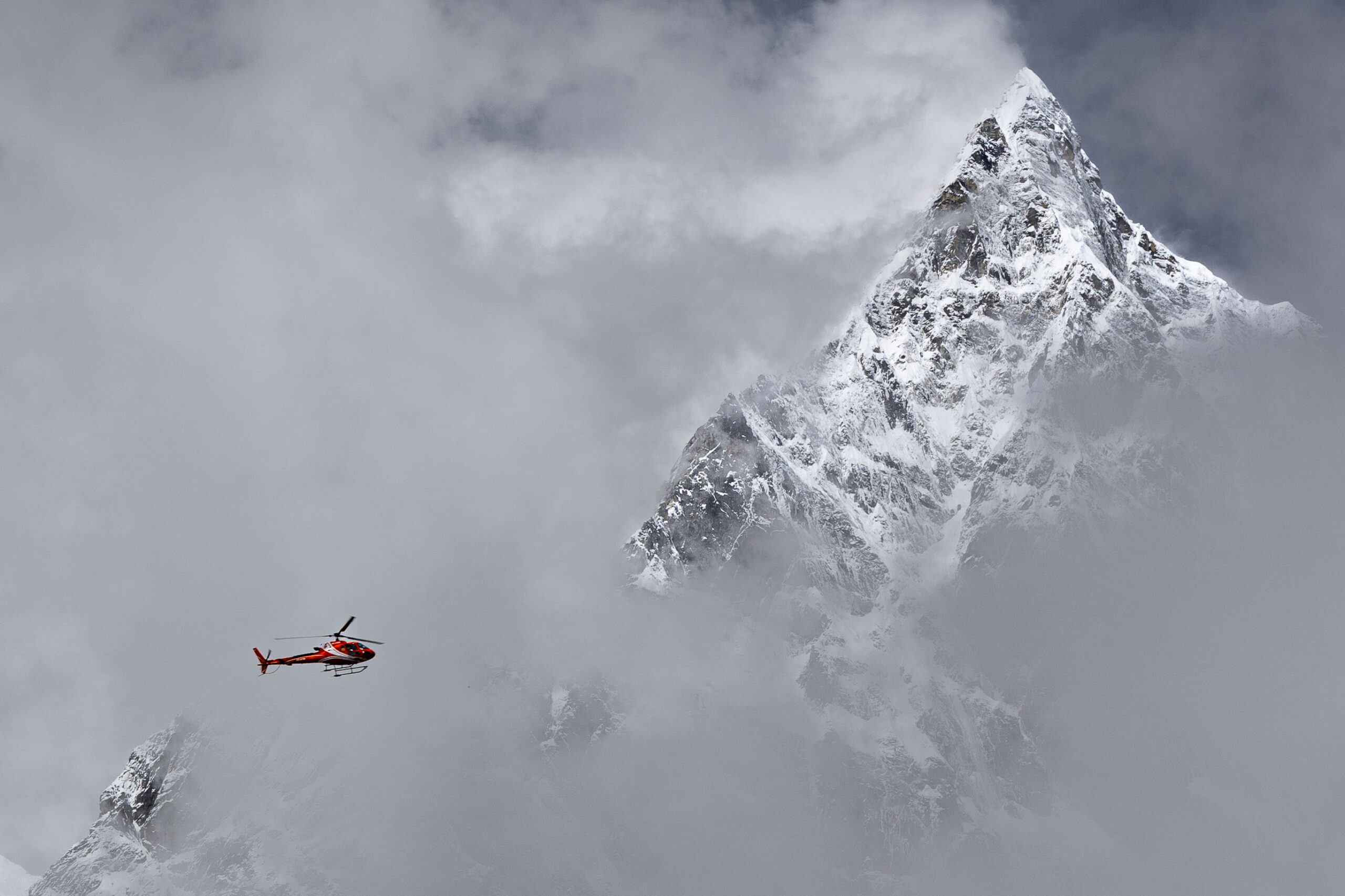 Helicopter flying near Himalayan peaks in Nepal