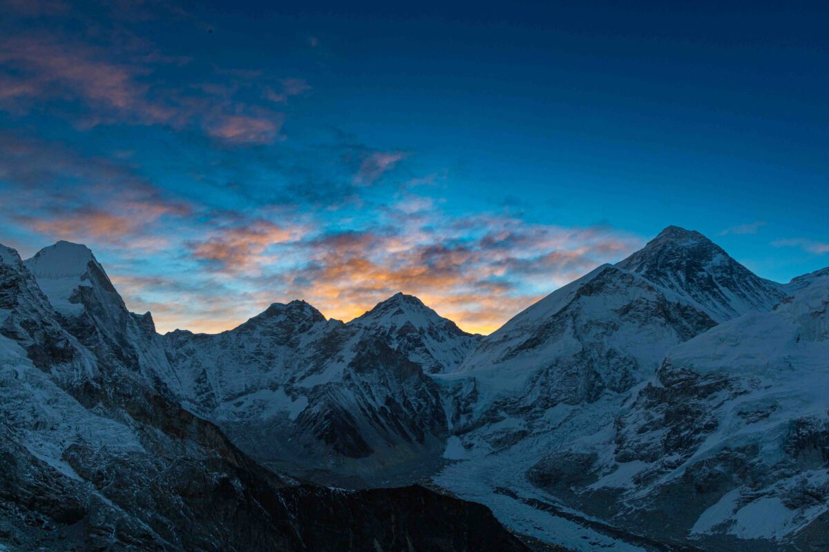 multi colored sunrise behind mt. everest