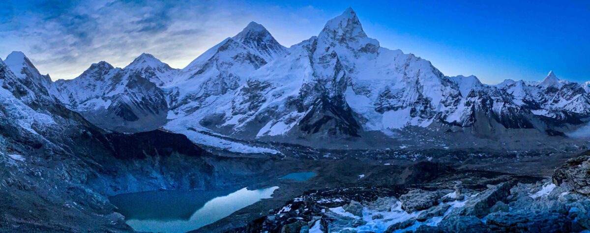 Panoramic sunrise view of Mount Everest, Nuptse, glacial lakes, and the Khumbu Valley in Nepal.