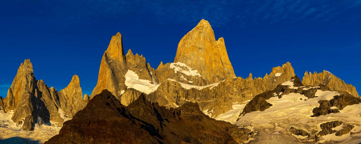 Early sunlight illuminates Mt. Fitz Roy and surrounding mountains in Argentina