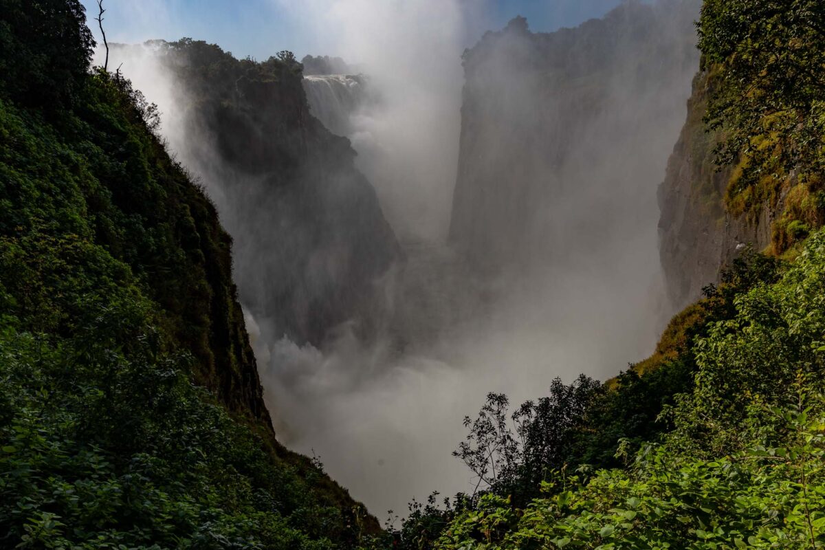 Thundering Victoria Falls in Zimbabwe fills the river gorge with fog