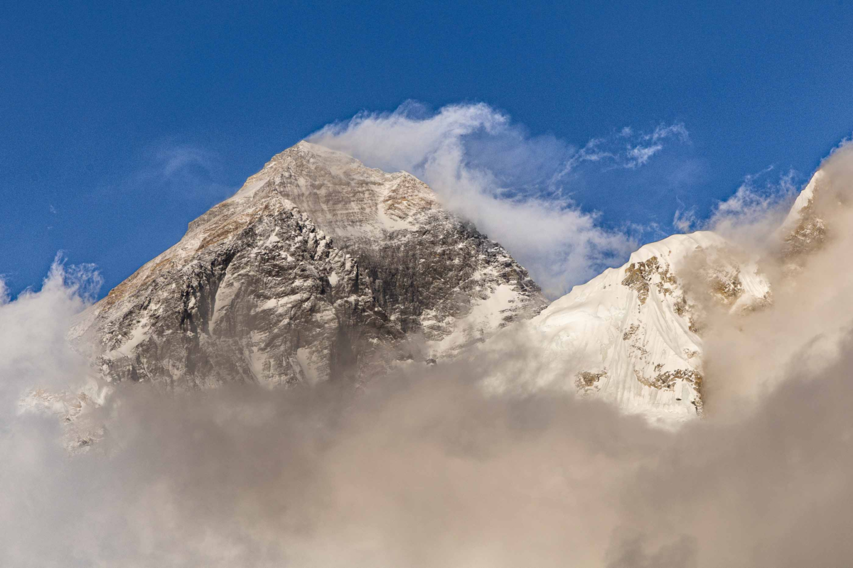 Mount Everest emerging through clouds in the Himalayas of Nepal