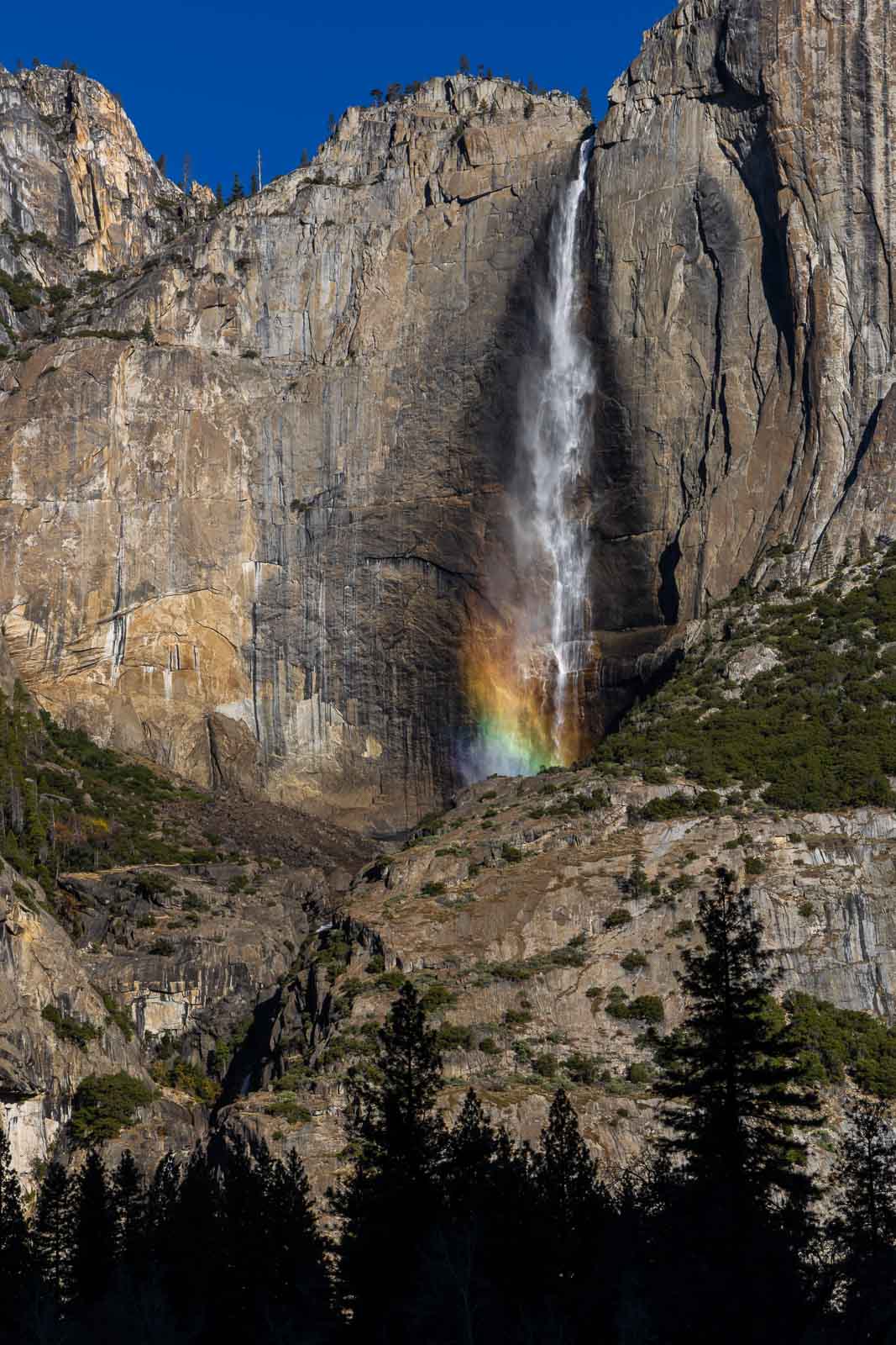 Yosemite Falls with a rainbow visible in the waterfall spray